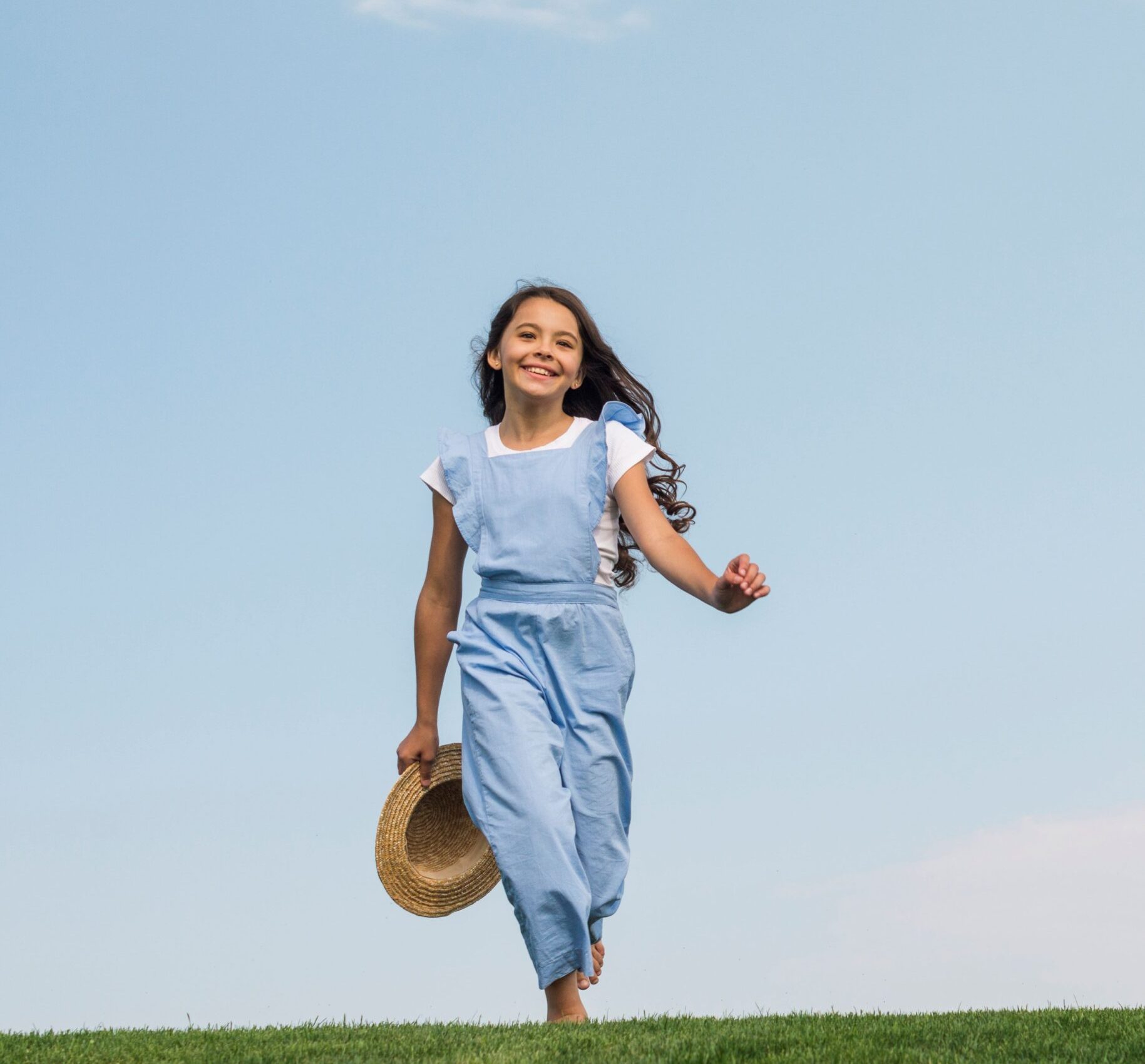 front-view-cute-girl-walking-grass
